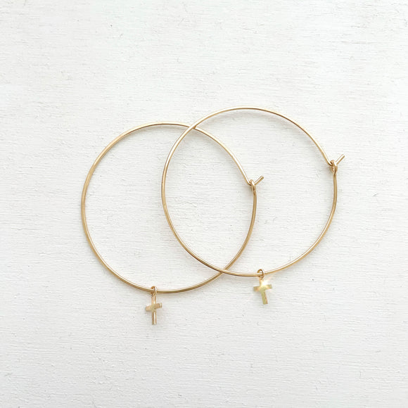 Keep your faith close wherever you go.  These lightweight Cross Hoop Earrings are large yet so dainty with removable mini cross charms.  Each cross charm is carefully handmade with 14k Gold Filled.     14K Gold Filled  Cross size: 7mm x 6mm (0.27
