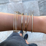 Just the perfect touch of Smart Chic + Minimalist.  The simple classic bangle is a timeless style that transcends season and elevates your stacking game with other bracelets.   14k gold-filled