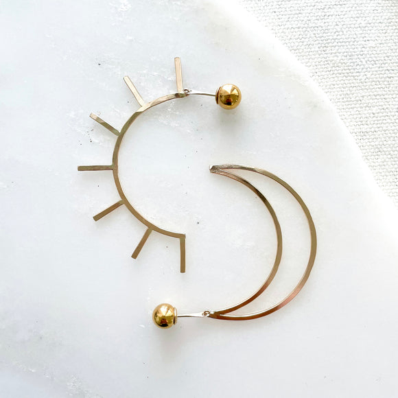 Live by the Sun, Love by the Moon. One cannot exist without the other.  The Equinox's perfect balance of sun and moon inspired this bold, dramatic and versatile design. They are reversible and can be worn in two ways: sun/moon in the front or back with the elegant 14k gold-filled ball backings.     14k Gold Filled  Sun: 2.5