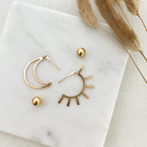 Live by the Sun, Love by the Moon. One cannot exist without the other.  The Equinox's perfect balance of sun and moon inspired this bold, dramatic and versatile design. They are reversible and can be worn in two ways: sun/moon in the front or back with the elegant 14k gold-filled ball backings.     14k Gold Filled  Sun: 1.5