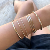 Smart Chic + Minimalist Bold  The Slim Dome bangle is a timeless classic with a modern look that transcends season or any style. It adds an accent of elegant casual to your everyday wear and elevates your stacking game with other bracelets.      14K gold-filled