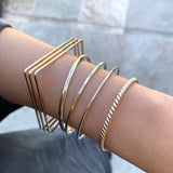 Smart Chic + Minimalistic Bold  Urban inspired retro look with the modern accent.  Square Edge Uptown Bangle is a statement piece with a unique square silhouette and a touch of elegant casual that transcends season or any style. It's perfect on its own or stacked with other bracelets.     14k gold-filled 