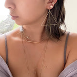 The Triangle Threader 2.0 elevates the original design to the chicest with the addition of the dainty chain threader.    Despite their large size, these playful threaders embody a feminine look in the most delicate way. Perfect for everyday wear from work to play.      14K Gold-Filled  6 5/8” length