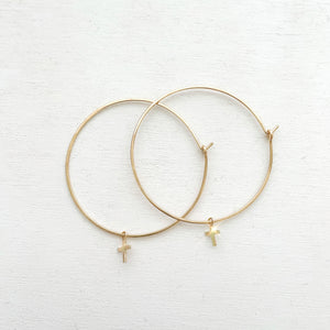 Keep your faith close wherever you go.  These lightweight Cross Hoop Earrings are large yet so dainty with removable mini cross charms.  Each cross charm is carefully handmade with 14k Gold Filled.     14K Gold Filled  Cross size: 7mm x 6mm (0.27" x 0.23")  Hoop size: 50mm (2") in diameter Keep your faith close wherever you go.  These lightweight Cross Hoop Earrings are large yet so dainty with removable mini cross charms.  Each cross charm is carefully handmade with 14k Gold Filled.     14K Gold Filled  Cr