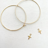 Keep your faith close wherever you go.  These lightweight Cross Hoop Earrings are large yet so dainty with removable mini cross charms.  Each cross charm is carefully handmade with 14k Gold Filled.     14K Gold Filled  Cross size: 7mm x 6mm (0.27" x 0.23")  Hoop size: 50mm (2") in diameter 