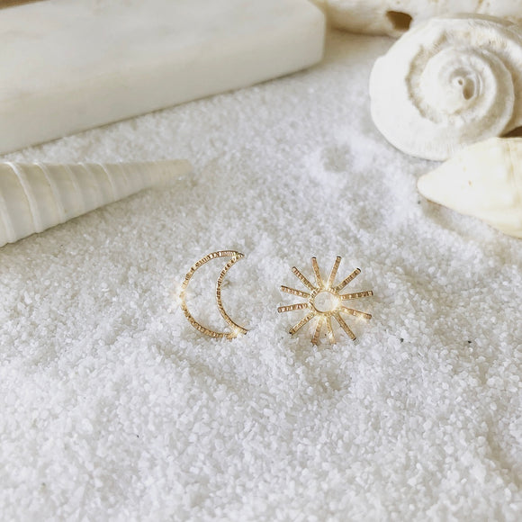 LIVE BY THE SUN, LOVE BY THE MOON. ONE CANNOT EXIST WITHOUT THE OTHER.  Make a statement with this asymmetric SUN and MOON studs.  This is definitely a go-to studs that fit in any style.  Materials  14K Gold Filled  Size  1/2