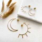 Live by the Sun, Love by the Moon. One cannot exist without the other.  The Equinox's perfect balance of sun and moon inspired this bold, dramatic and versatile design. They are reversible and can be worn in two ways: sun/moon in the front or back with the elegant 14k gold-filled ball backings.     14k Gold Filled  Sun: 2.5"H x 1 1/4"W  Moon: 1 7/8"H x 1 1/4"W
