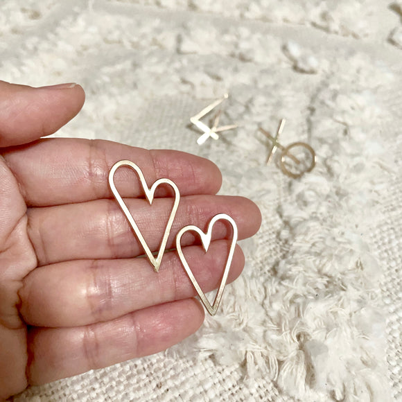 Handwritten love letters are the perfect reminders that love is all around. Show your love without words. These Heart Earrings are very chic, classy and bold style. Two hearts one love♡︎     14k Gold Filled  Size: 1”H x 5/8”W     *handwritten collection pieces may have slight shape variations.   
