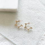 Dewdrop Collection - You didn't know you need, but now you won't be able to live without!  Start a new day with dewdrop hoops that bring magic and spark joy in your life.  Chic element and edgy silhouette combined to create the perfect pair of unique statement hoops. This small hoops go perfect for everyday wear with any stack.      14k Gold Filled  Approximately 3/4" diameter 