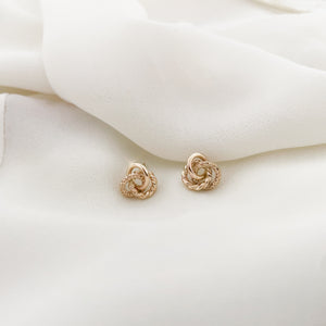 Classic jewelry vibe with elegant touch embodies the simplicity of modern sophistication.  These show-stopping TRIO Knot studs feature three different textures in a striking and statement-worthy design.  Stunningly beautiful and effortless, these studs add elegant yet glamorous touch with classic jewelry vibe to your everyday.     SIZE: 3/8" (10mm)