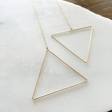 The Triangle Threader 2.0 elevates the original design to the chicest with the addition of the dainty chain threader.    Despite their large size, these playful threaders embody a feminine look in the most delicate way. Perfect for everyday wear from work to play.      14K Gold-Filled  6 5/8” length