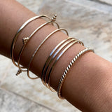 Smart Chic + Minimalist Bold  The Dewdrop bangle is a timeless classic with a modern look that transcends season or any style. It adds an accent of elegant casual to your everyday wear and elevates your stacking game with other bracelets. 