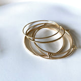 Smart Chic + Minimalist Bold  The Slim Dome bangle is a timeless classic with a modern look that transcends season or any style. It adds an accent of elegant casual to your everyday wear and elevates your stacking game with other bracelets.      14K gold-filled