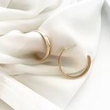 UNLEASH YOUR INNER STRENGTH AND AWAKEN THE HIDDEN GODDESS WITHIN.  Feminine strength merges with natural elegance through our Goddess Band. The smooth texture and design of a golden band symbolize independence and confidence. You are bold, brave, and courageous. Embrace the elegance of natural beauty with our Goddess Band Hoops and bring out the goddess inside you. Whether for work or an evening out, our Goddess Collection will surely add boldness to your look.   Unisex. 14K Gold Filled. Nickel Free.